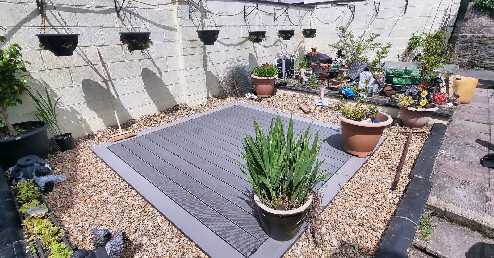 Grey composite decking framed by a gravel border